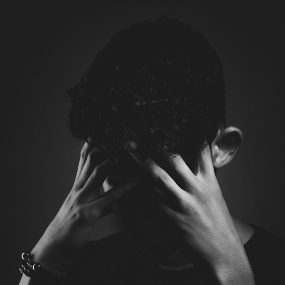 anxiety A man covering his face with his hands, expressing distress or frustration.